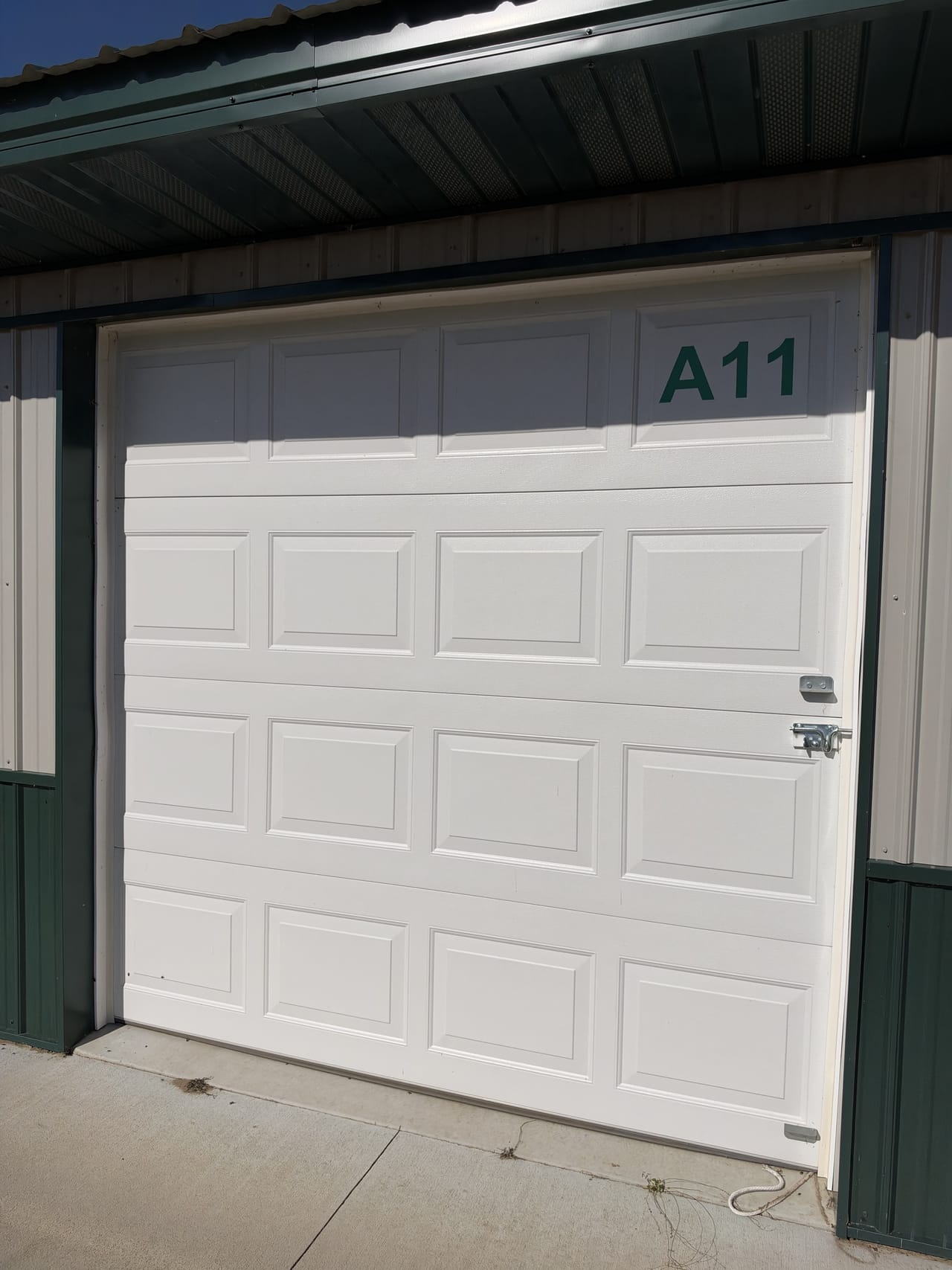 The closed white overhead door of midsize unit A11